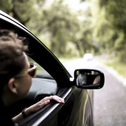 Man looking out of the window driving in a taxi